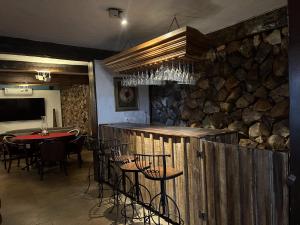 a restaurant with a table and chairs and a stone wall at Historical Mansion in Pampulha in Belo Horizonte