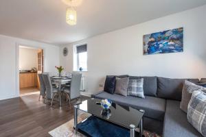 a living room with a couch and a table at Apartment in Ashford 2 Bedroom private parking for contractors, families & holiday in Kennington