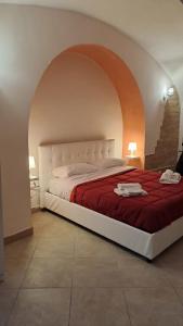 a bedroom with a large bed with a red blanket at Napoli Apartment in Naples