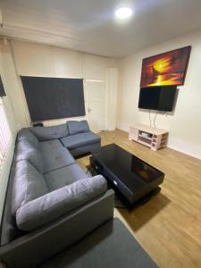 a living room with a couch and a flat screen tv at Kappas place HENDRIKA J VELDKAMPSTRAAT 55 in Paramaribo