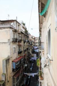a city street with clothes hanging from buildings at BlackWoody Contemporary Rooms - Napoli Centro Storico in Naples