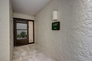 a clock on a wall next to a door at 2107 Beach Wood in Amelia Island