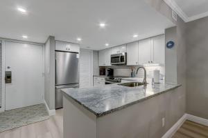 a kitchen with white cabinets and a granite counter top at 2107 Beach Wood in Amelia Island