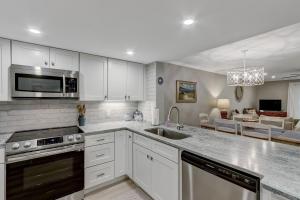 a kitchen with a sink and a stove top oven at 2107 Beach Wood in Amelia Island