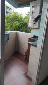 a backyard kitchen with a sink and a window at Apartamento praia do tombo Guarujá in Guarujá