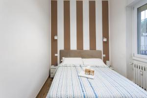 a small bedroom with a bed with a box on it at Casa San Paolo - Pavia Città - by Host4U in Pavia