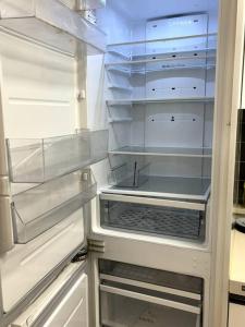 an empty refrigerator with its door open in a kitchen at Clean 2 SuperSingle Beds House in Seoul