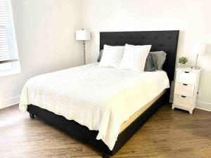 a bedroom with a large bed and a night stand at Spacious 2 Bedroom Venice Beach Villa in Los Angeles