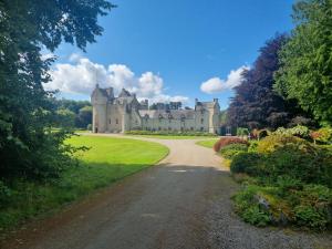 a castle with a road leading to it at Coal Office Aberlour in Aberlour