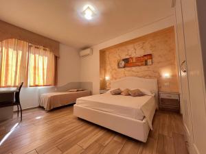 A bed or beds in a room at Bella Tropea Accommodation