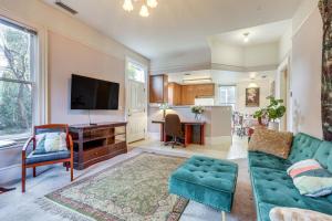 a living room with a couch and a tv at Eclectic Sacramento Home about Half Mi to Downtown! in Sacramento
