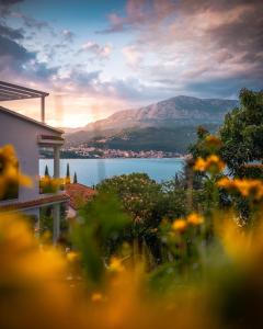 a view of the lake from a house with flowers at Zazenda House in Herceg-Novi