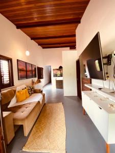 a large living room with a couch and a sink at Casa Vida Li in Ilha de Boipeba