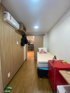 a small room with a bed and a red dresser at FLAT NA PRAIA DO MEIO in São-José-do-Ribamar