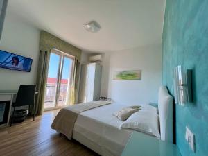 a bedroom with a large bed and a fireplace at Bella Tropea Accommodation in Tropea