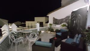 a balcony with chairs and a table at night at CASA RURAL ELENYR in Calera de León