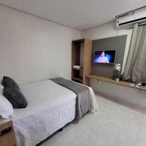 um quarto com uma cama e uma televisão de ecrã plano em Apartamento mobilhado,5 minutos do aeroporto em Marabá
