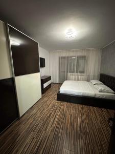 a bedroom with a bed and a television in it at LukApartaments in Tulcea