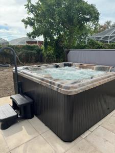a hot tub on a patio with a bench at Vera’s vacation in Bradenton