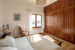 una camera da letto con un letto bianco e una finestra di Colares beach house, pool child friendly a Colares Altre 55 foto