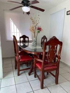 a dining room table with chairs and a ceiling fan at Depa Los abuelos en Puerto Vallarta in Puerto Vallarta