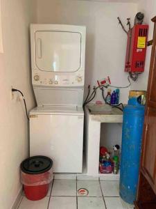 a microwave sitting on top of a refrigerator in a room at Depa Los abuelos en Puerto Vallarta in Puerto Vallarta