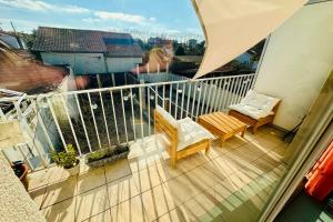 a balcony with two chairs and a table at Charming well-equipped apartment with wifi in Bordeaux