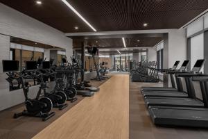 a gym with rows of treadmills and machines at AC Hotel by Marriott Washington DC Capitol Hill Navy Yard in Washington