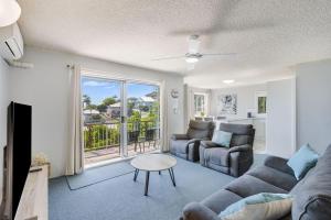 a living room with a couch and a table at Skyline Unit 12 in Gold Coast