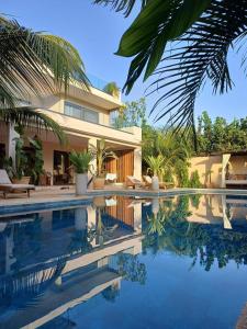 a house with a swimming pool in front of it at Villa YEMAYA - Villa d'hôtes in Ngaparou