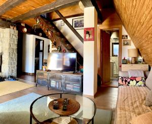 a living room with a couch and a tv at Holiday Home Dana Kopaonik in Kopaonik