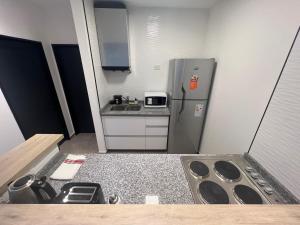 a small kitchen with a sink and a refrigerator at 4919 SOHO LIVE - Palermo Soho Apartments in Buenos Aires