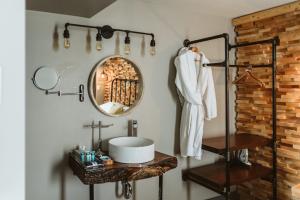 a bathroom with a sink and a mirror at The Grove Hotel in Kingsville