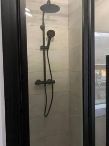 a shower with a blow dryer in a bathroom at Apartment in Midsomer Norton High St in Midsomer Norton