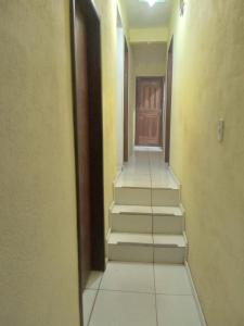 a hallway with stairs leading to a wooden door at Pousada Villas Colossos in Lençóis