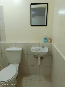 a bathroom with a toilet and a sink at Deca Homes Staycation in Manila