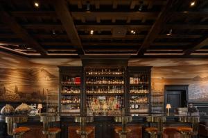 a bar with a large shelf of liquor bottles at Todos Santos Boutique Hotel in Todos Santos