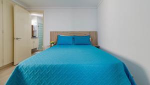 un letto blu con cuscini blu in una camera da letto di Casa Tartaruga a Cartagena de Indias
