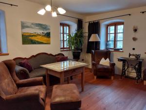 a living room with a couch and a table at Sunny holiday home near the forest in Stadlern