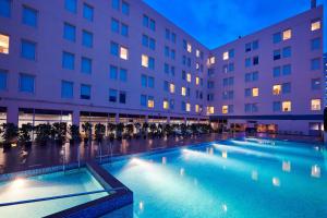 a large swimming pool in front of a building at Aloft Bengaluru Whitefield in Bangalore