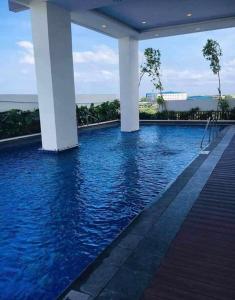 a swimming pool with blue water in a building at Le Palis Suite 