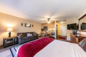 a living room with a large bed and a couch at Charming Studio Deluxe w/kitchen #215 at Donner Lake Village in Truckee