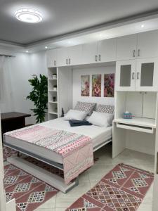 a bedroom with a large bed and white cabinets at شقة في قلب القاهرة الجديدة تطل على شارع التسعين الشمالي in Cairo