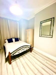 a bedroom with a bed and a mirror on the wall at One Bedroom Ground Floor Apartment In Central London in London