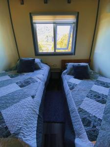En eller flere senge i et værelse på Cabaña Entre Mar y Cordillera