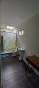 a bathroom with a toilet and a sink at REEF ON THE WATER in Tamanique