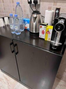 a counter with bottles of water and a blender at شقة سكنية بغرفتين نوم in Al Jubail