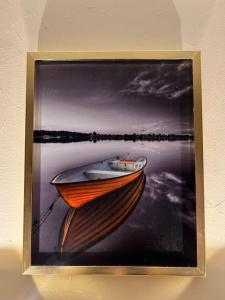 a picture of a painting of a boat on the water at شقة سكنية بغرفتين نوم in Al Jubail