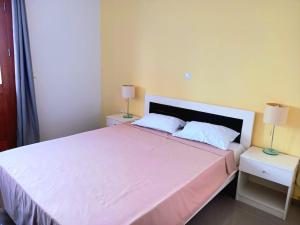1 dormitorio con 1 cama blanca grande y 2 mesitas de noche en Apartamento em Santa Maria- Espaçoso&Confortável, en Santa Maria