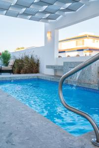 a swimming pool with blue water in a building at New 5 Br + Pool Luxury Beach Home Vista Hermosa in Puerto Peñasco
